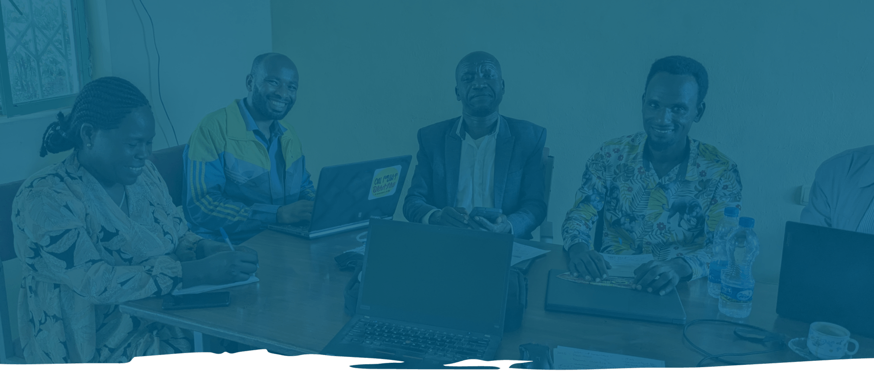 Bible translation worker at laptop